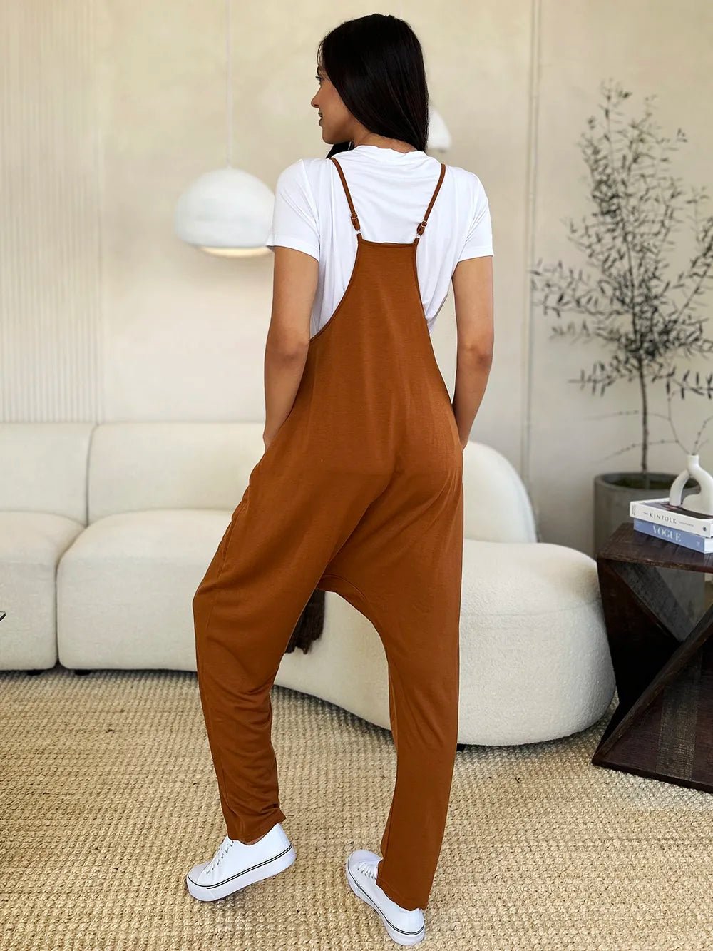 Women’s sleeveless V-neck wide-leg jumpsuit with pockets, from Plush Fashion Hub, shown in a full-length view.