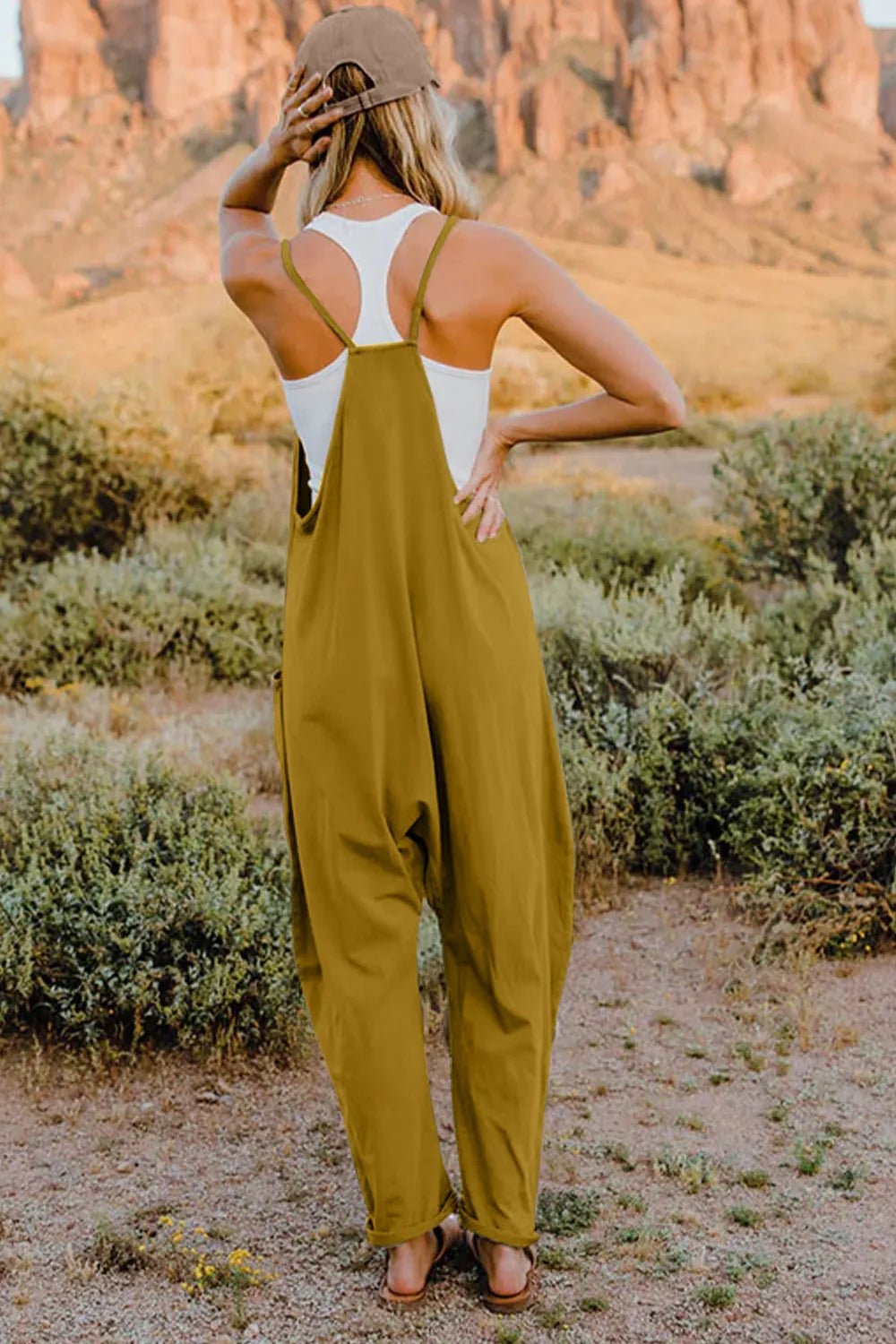 Women's lightweight sleeveless V-neck jumpsuit with pockets, casual romper by Trendsi, shown in a full-length image.