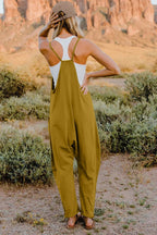 Women's lightweight sleeveless V-neck jumpsuit with pockets, casual romper by Trendsi, shown in a full-length image.