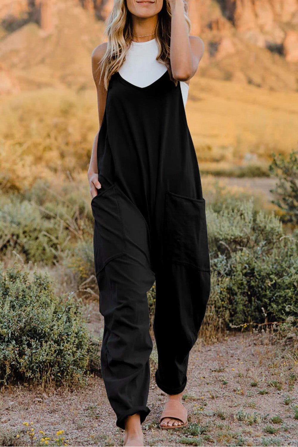 Women's lightweight sleeveless V-neck jumpsuit with pockets, casual romper by Trendsi, shown in a full-length view.