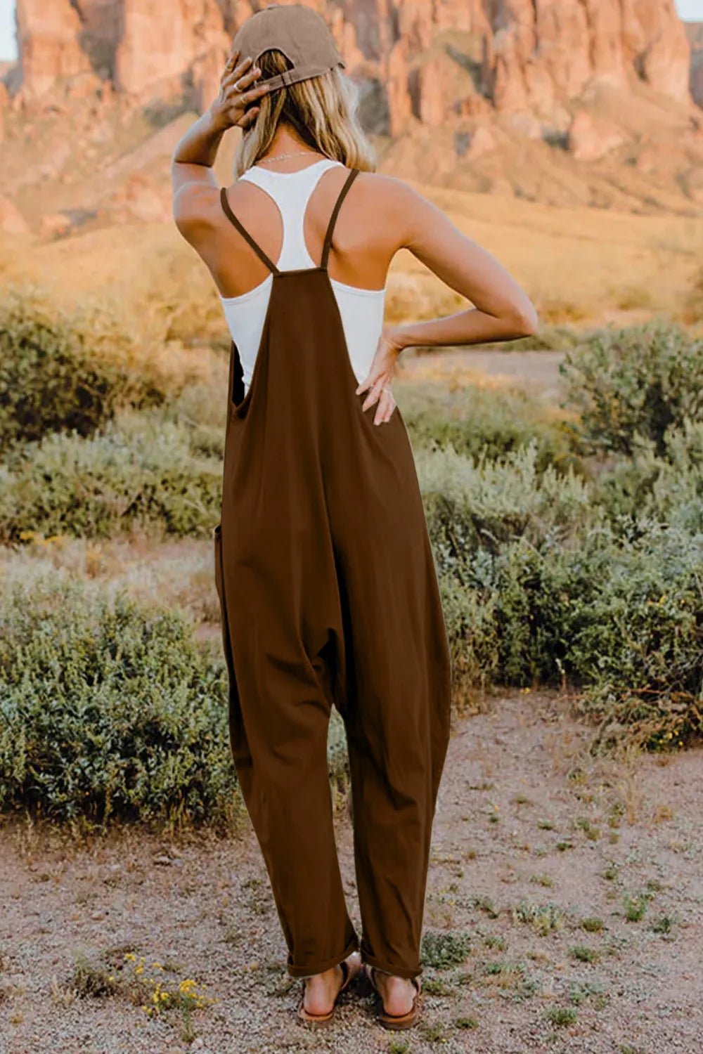 Women's lightweight sleeveless V-neck jumpsuit with pockets, casual romper by Trendsi, shown in full size on a woman model.
