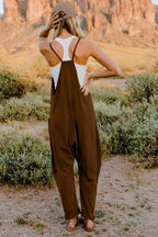 Women's lightweight sleeveless V-neck jumpsuit with pockets, casual romper by Trendsi, shown in full size on a woman model.