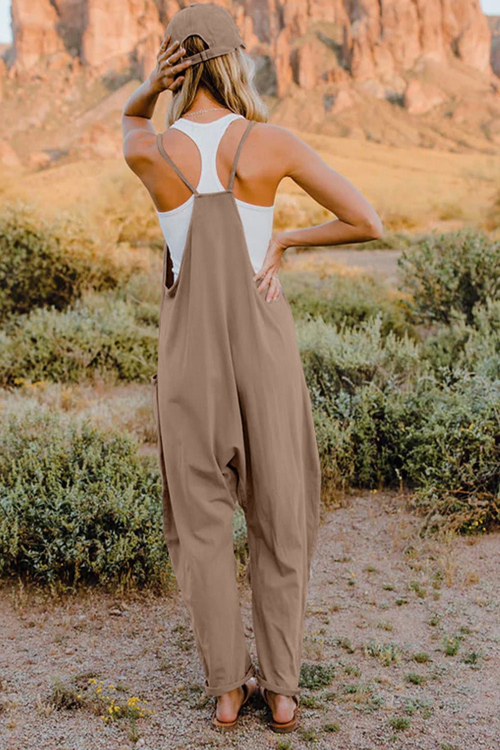 Women's lightweight sleeveless V-neck jumpsuit with pockets, casual romper from Trendsi, shown on a model.