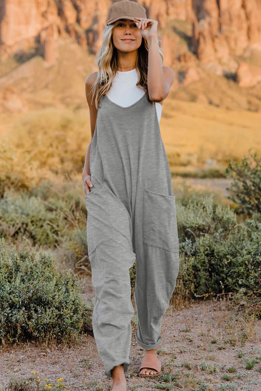 Women’s V-neck sleeveless jumpsuit with pockets, lightweight casual romper, stylish women's apparel by Trendsi.