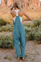 Women's lightweight V-neck sleeveless jumpsuit with pockets, casual romper by Trendsi showing front view and relaxed fit.