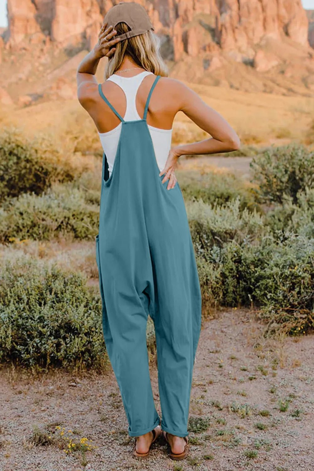 Women's lightweight V-neck sleeveless jumpsuit with pockets, casual romper by Trendsi showing front view and relaxed fit.
