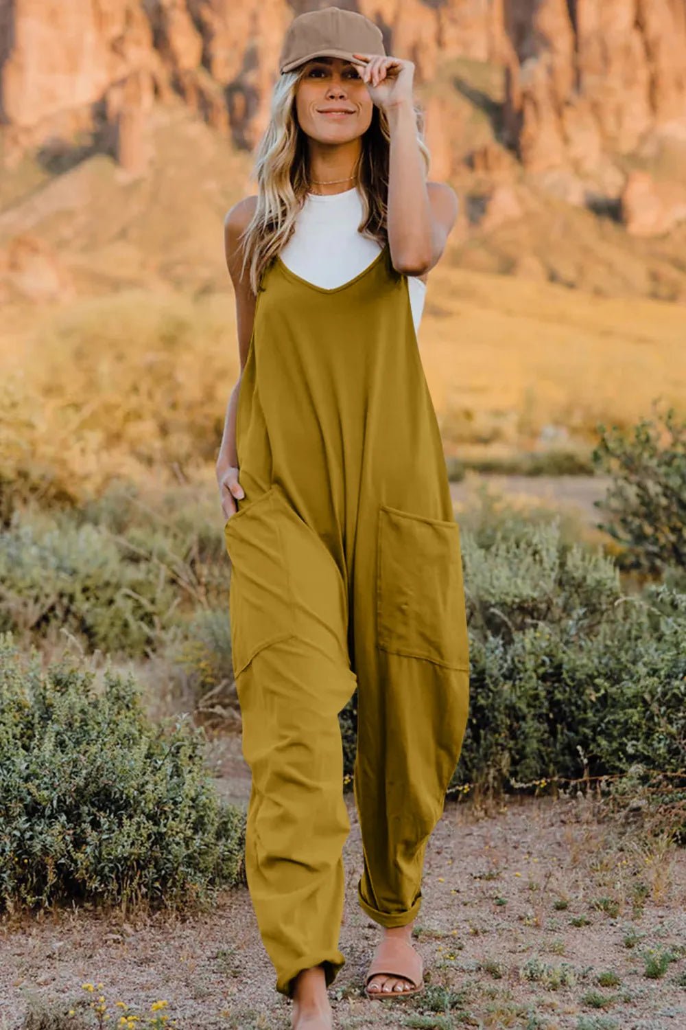 Women's lightweight sleeveless V-neck jumpsuit with pockets, casual romper from Trendsi, shown in a full-length view.