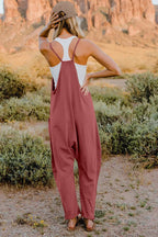 Women's lightweight V-neck sleeveless jumpsuit with pockets, casual romper from Trendsi, shown in a full-length view.