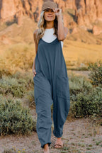 Women's lightweight V-neck sleeveless jumpsuit with pockets, casual romper from Trendsi, shown in a full-length front view.