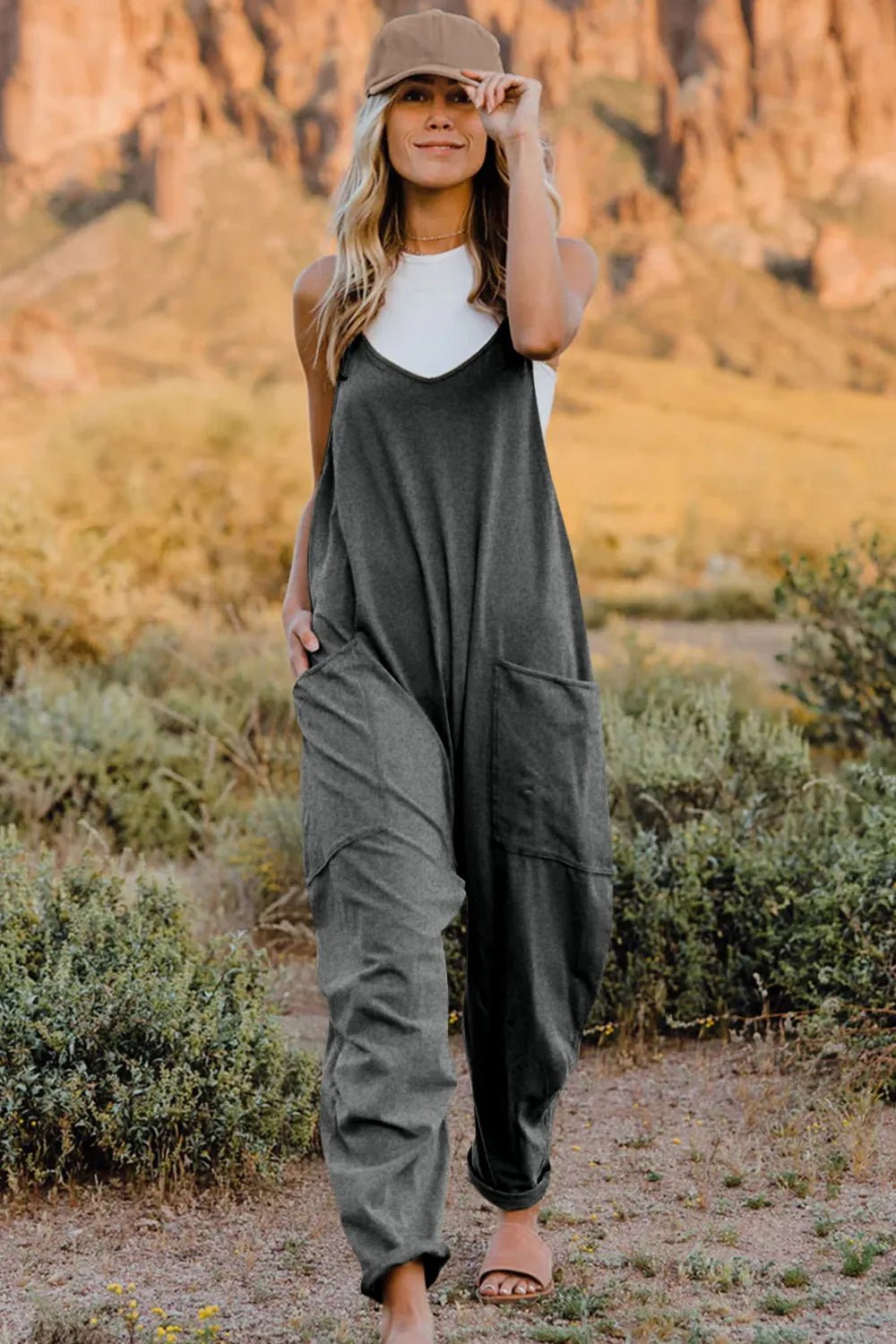 Women's V-neck sleeveless jumpsuit with pockets, lightweight casual romper, trendy women's apparel by Trendsi.
