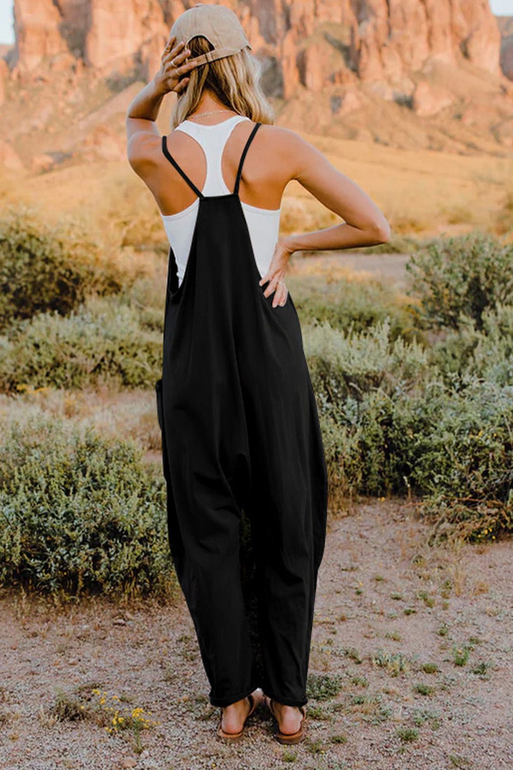 Women's lightweight V-neck sleeveless jumpsuit with pockets, casual romper from Trendsi, shown in full length.