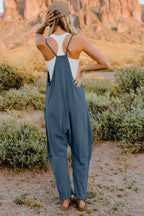 Women's lightweight V-neck sleeveless jumpsuit with pockets, casual romper by Trendsi, shown in full length.