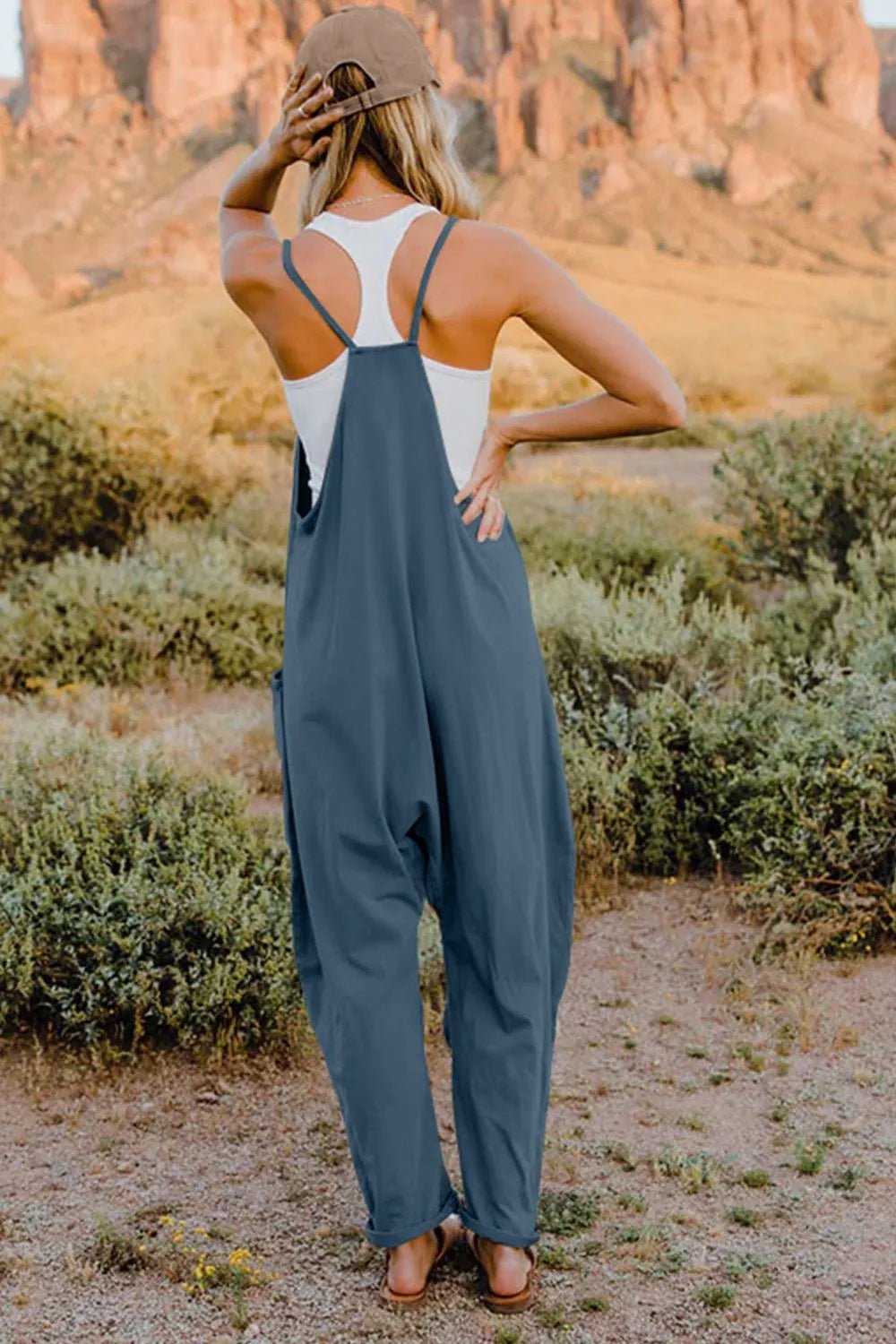 Women's lightweight V-neck sleeveless jumpsuit with pockets, casual romper by Trendsi, shown in full length.