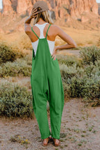 Women's lightweight V-neck sleeveless jumpsuit with pockets, casual romper from Trendsi, shown in a full-length view.