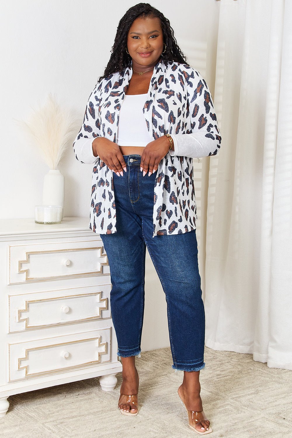 Women’s leopard print long sleeve knit cardigan by Plush Fashion Hub, soft and cozy layering piece with a stylish animal print design.