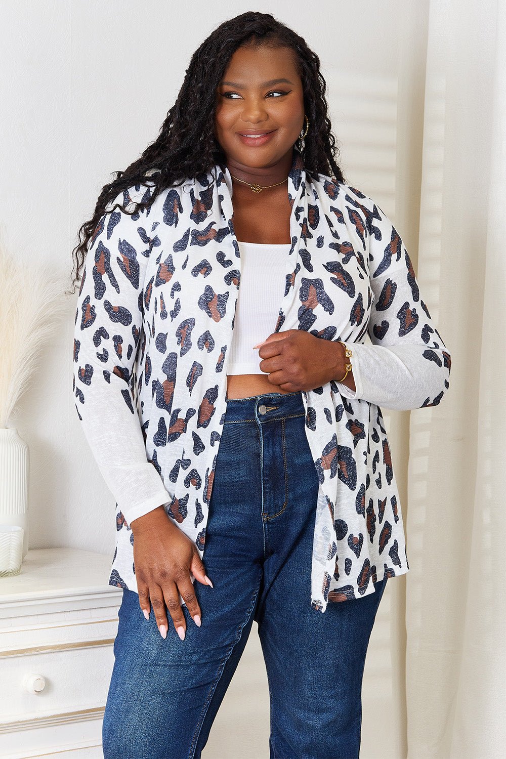 Women's leopard print long sleeve knit cardigan by Plush Fashion Hub, soft layering piece with stylish leopard pattern.