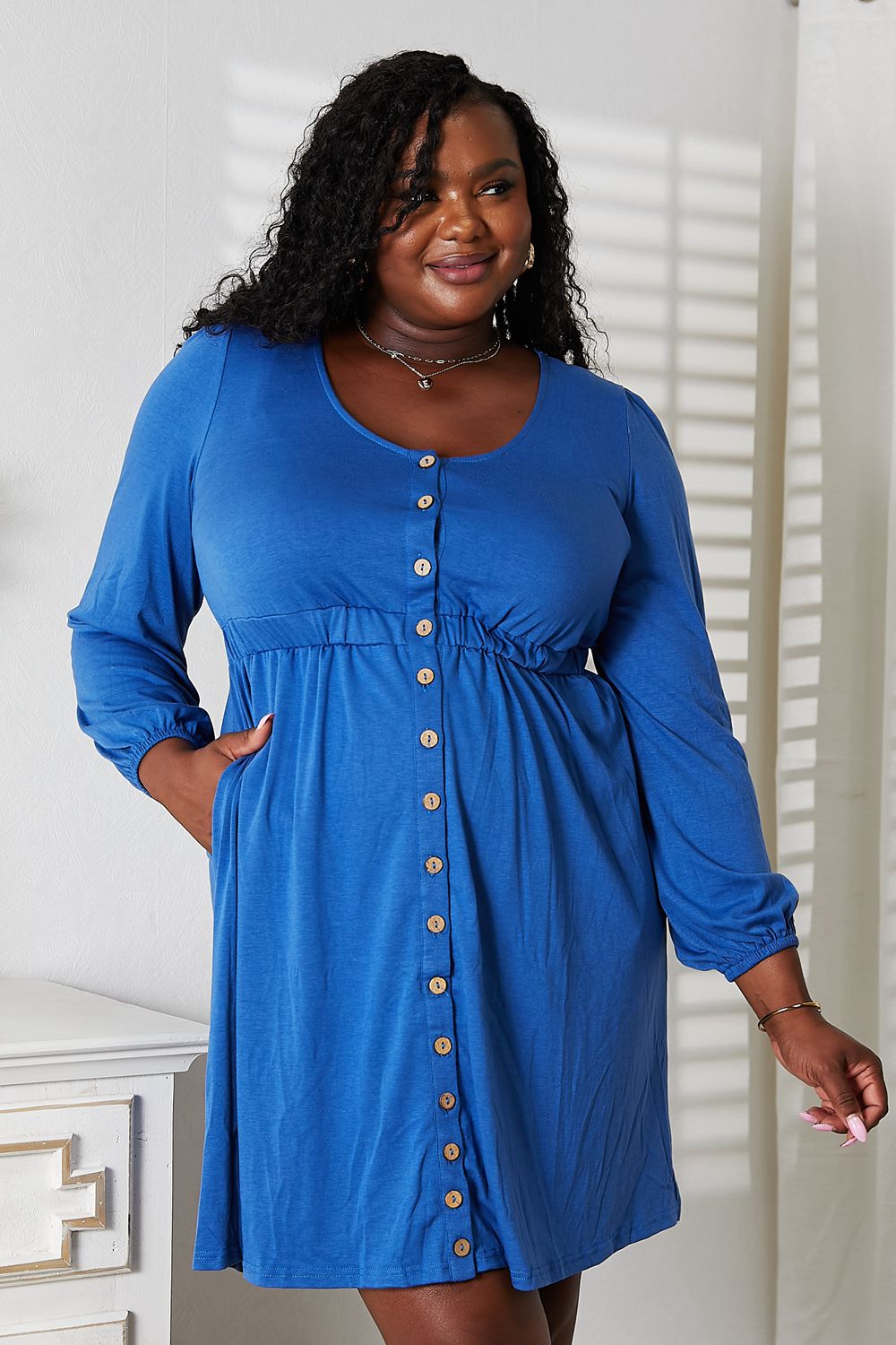 Women's long sleeve empire waist dress with pockets and scoop neck, midi length, by Trendsi, featuring a stylish and comfortable design.