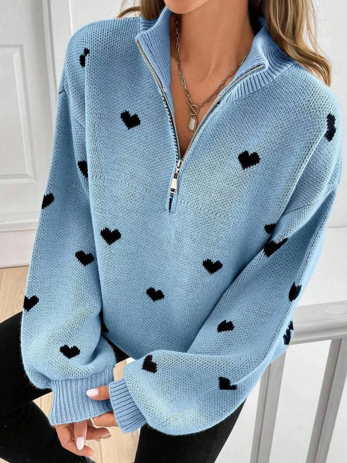 Plus size full heart half-zip long sleeve sweater by Trendsi, featuring a cozy design with a large heart detail on the front.