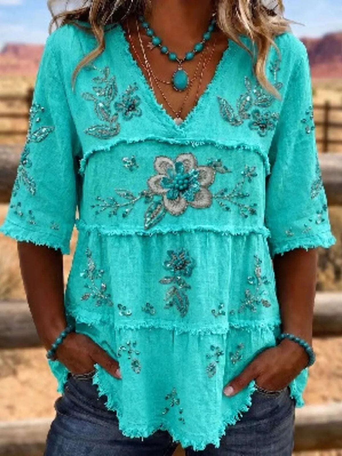 Plus size floral raw hem V-neck blouse by Trendsi, featuring full size shirt with feminine floral pattern and casual style.