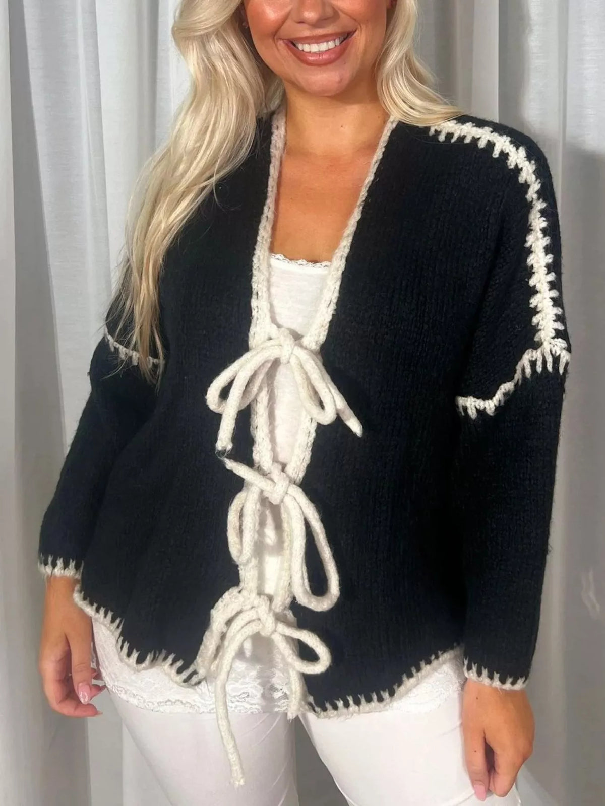 Trendsi tie front drop shoulder cardigan with long sleeves, ribbed cuffs, and a relaxed fit, shown in soft knit fabric.