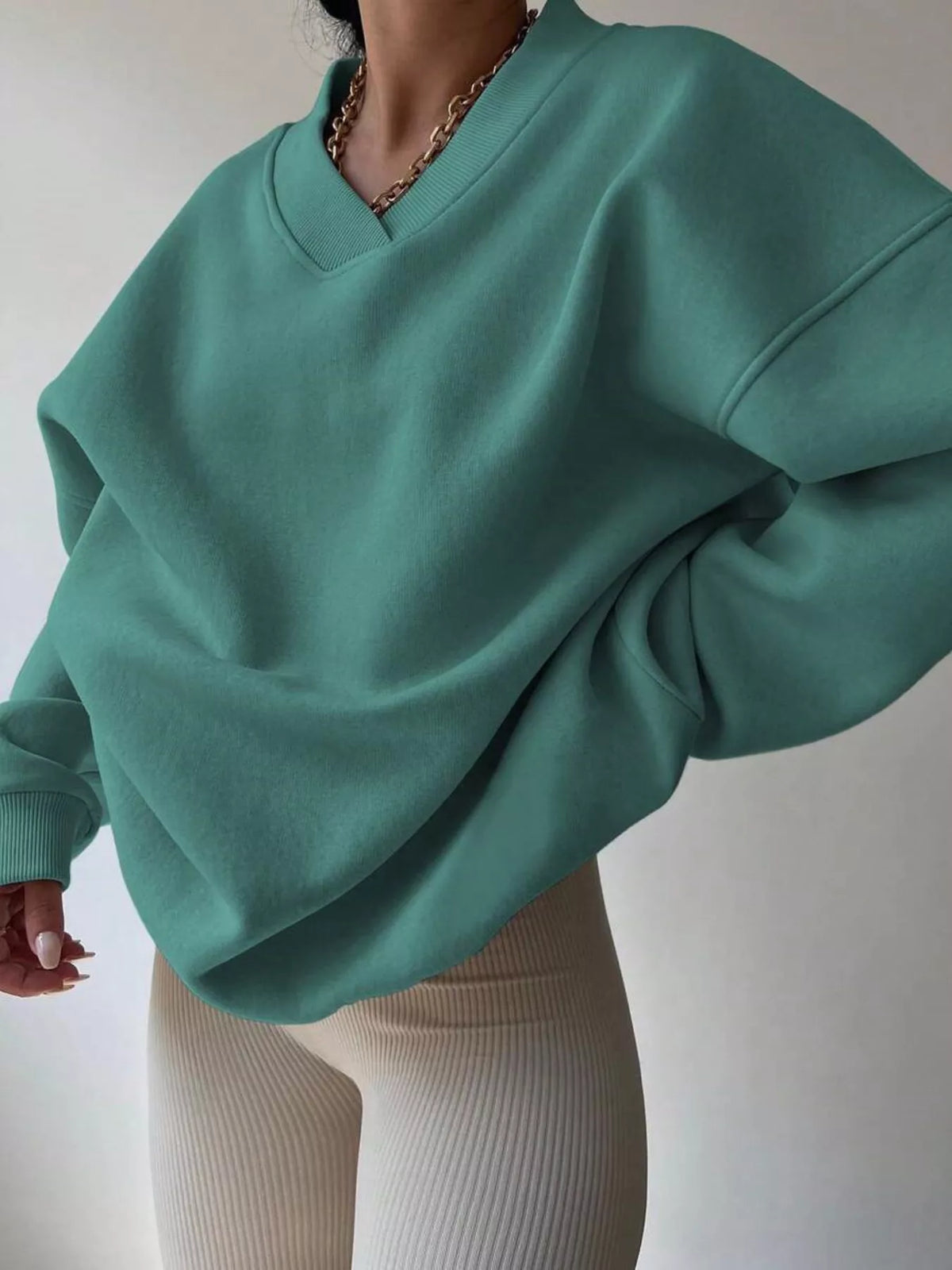 Oversized dropped shoulder long sleeve sweatshirt by Trendsi, showcasing relaxed fit and soft fabric in a casual style.