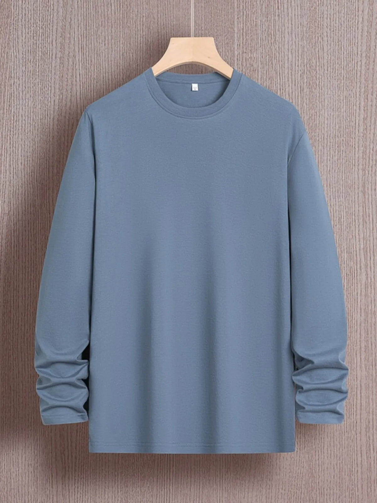 Men's plus size round neck long sleeve T-shirt from Trendsi, soft fabric, fitted style, shown on a model.