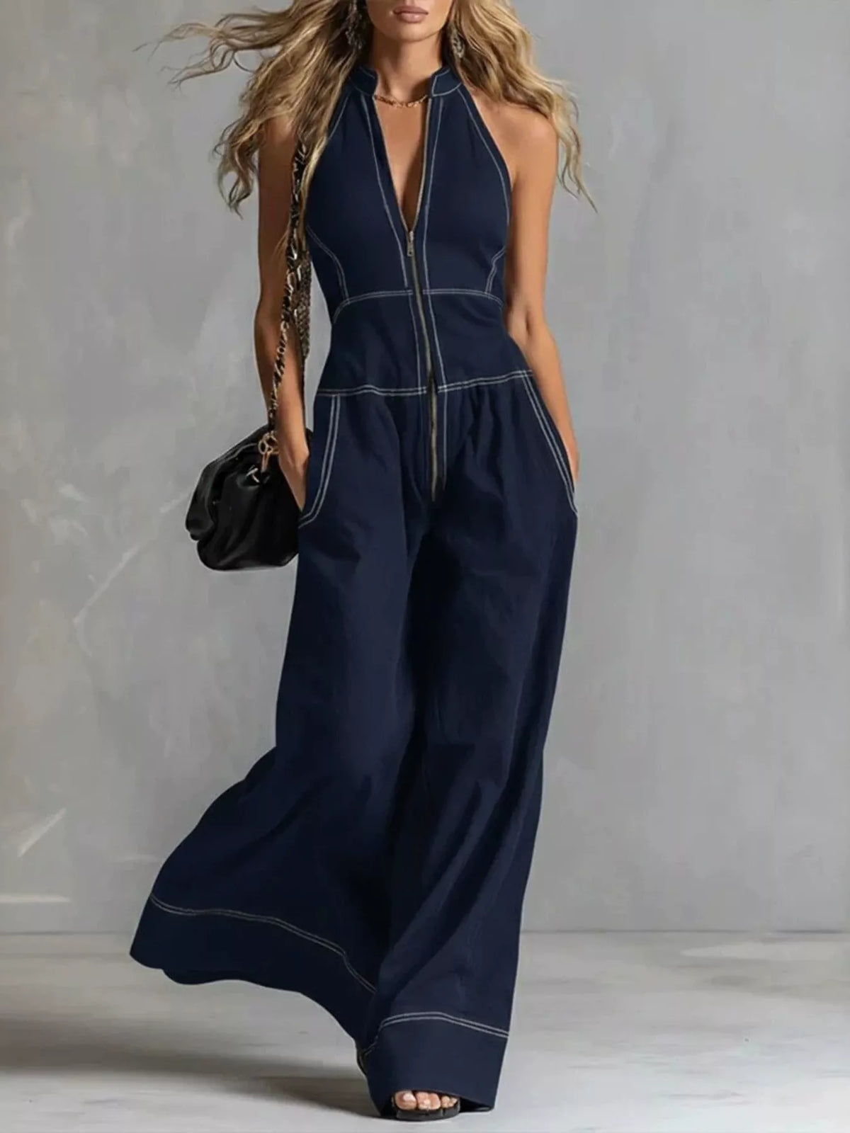Zip front sleeveless wide-leg jumpsuit by Trendsi, featuring a stylish fit and modern design, shown in a flat-lay image.