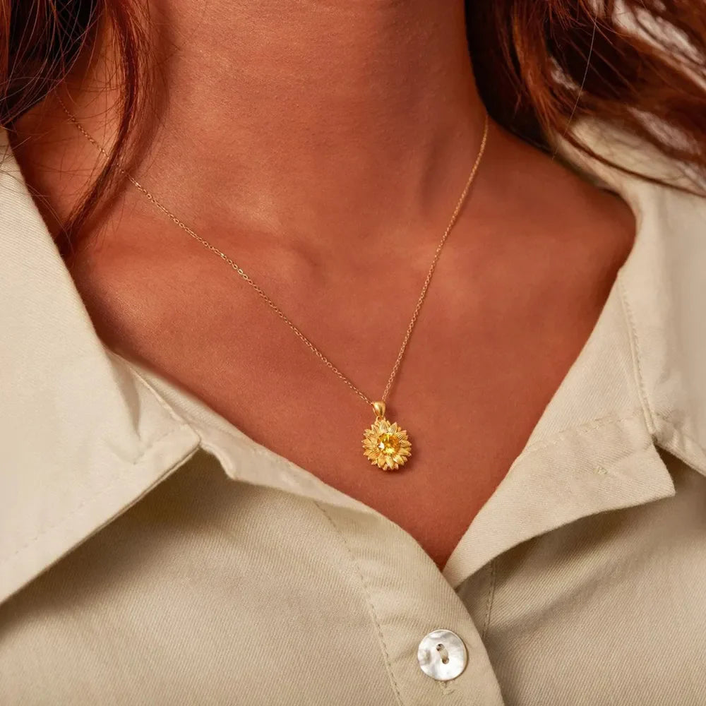 Gold-plated sunflower-shaped pendant necklace from Plush Fashion Hub featuring a detailed floral design.