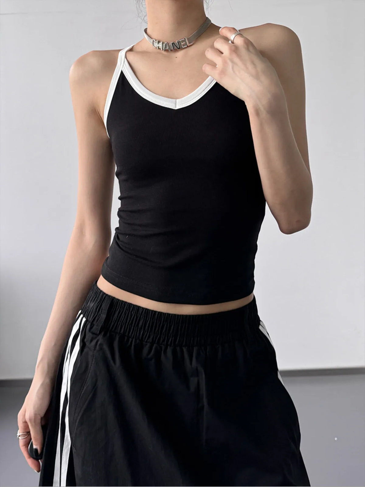 Black contrast trim cami top from Plush Fashion Hub featuring adjustable straps and a fitted design.