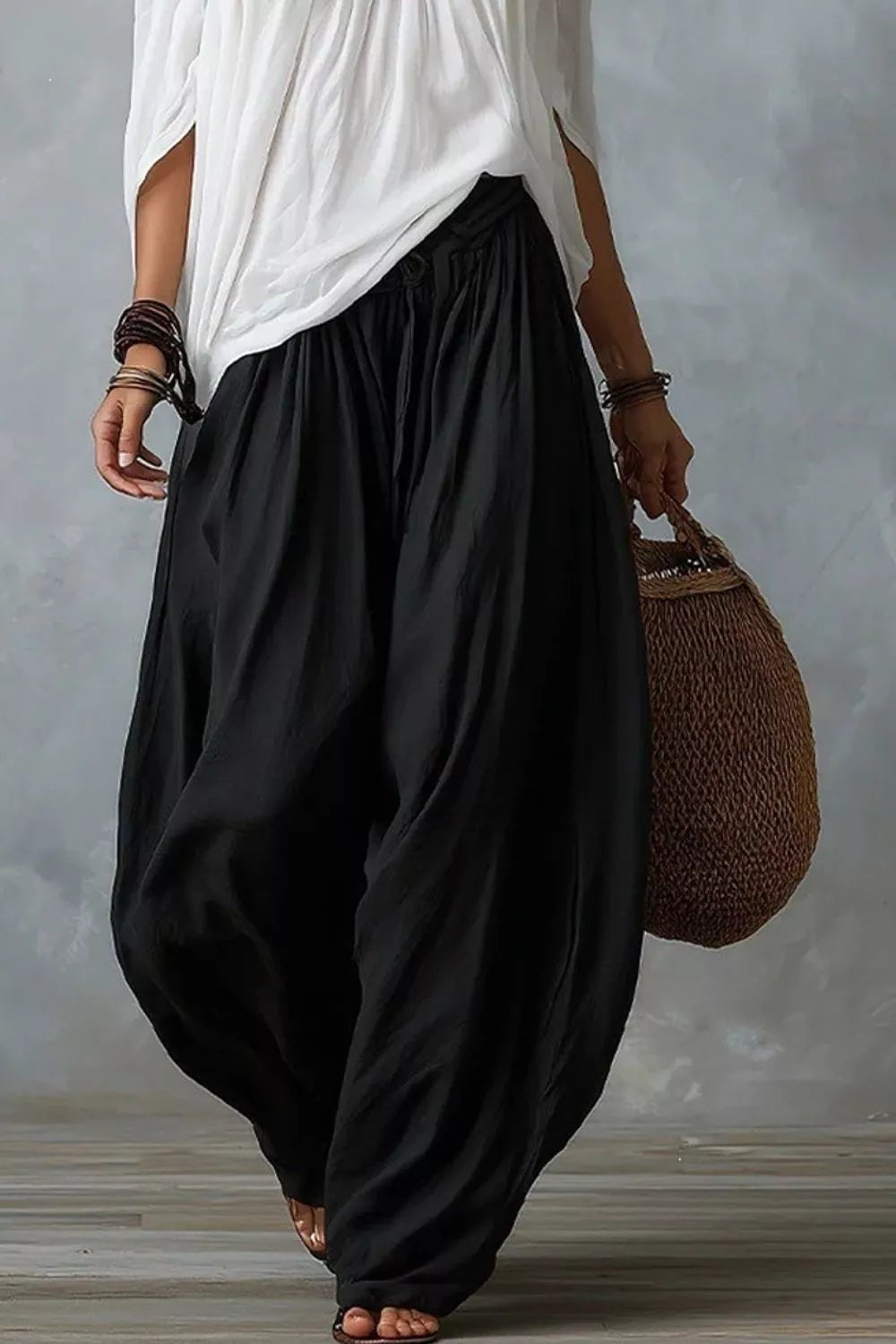 Plus size off-shoulder top and wide-leg pants matching set by Trendsi, featuring a stylish, comfortable design with a relaxed fit.