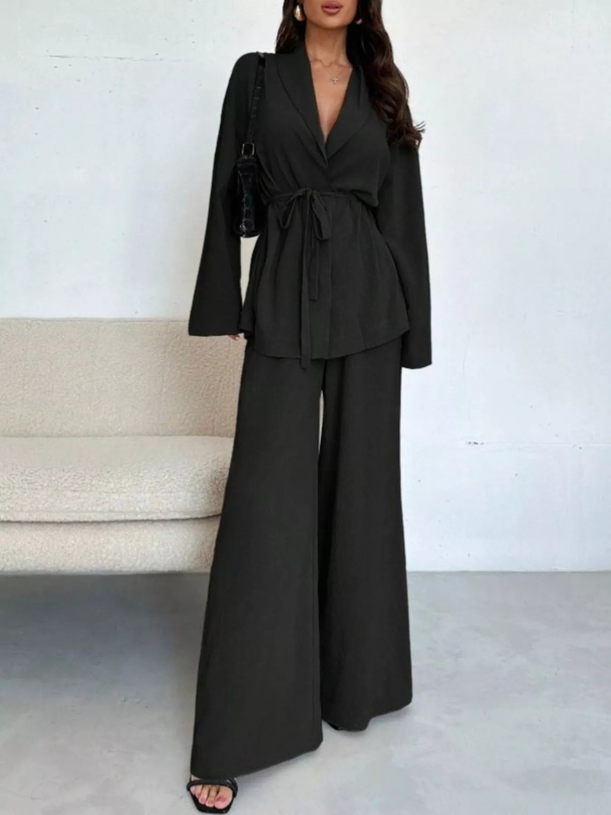 Textured tie waist top and wide-leg pants set for women by Trendsi, featuring a stylish and comfortable coordinated outfit.