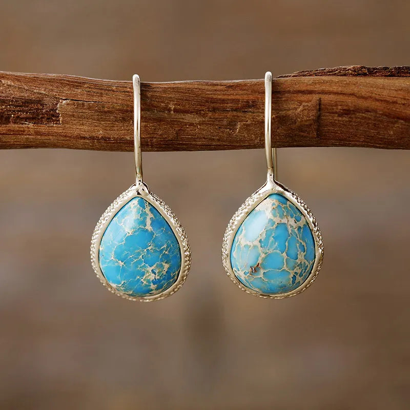 Copper natural stone teardrop earrings with a polished finish, featuring earthy tones and elegant teardrop shape.