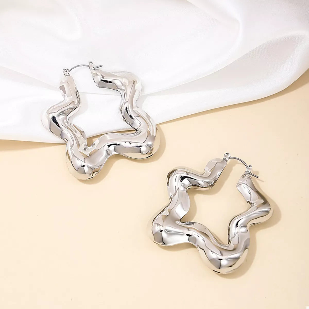 Star-shaped hoop earrings from Plush Fashion Hub featuring gold-tone metal and stylish celestial-inspired design.