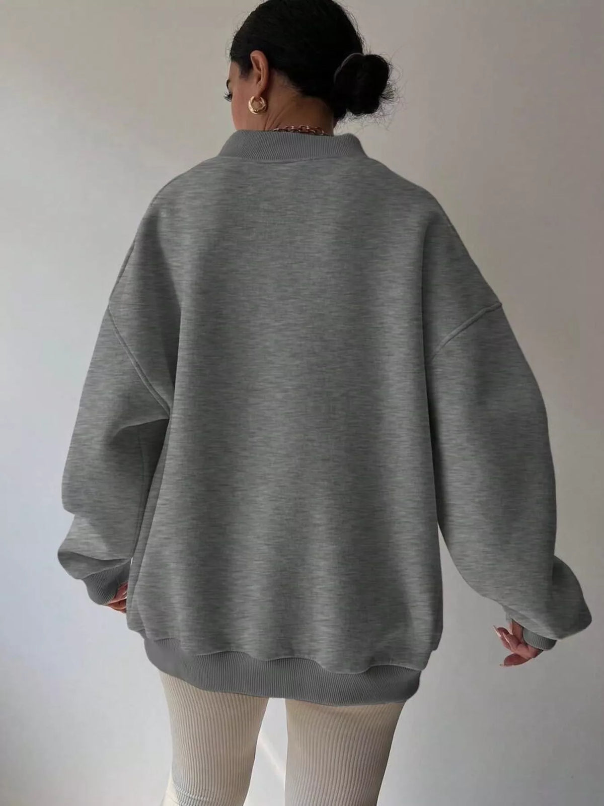 Oversized dropped shoulder long sleeve sweatshirt by Trendsi, soft fabric, relaxed fit, in a casual style, shown on a model.