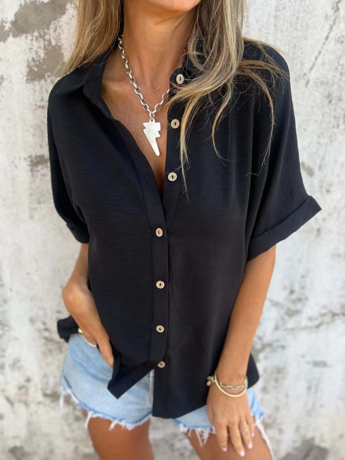Women's half sleeve collared button-down blouse from Plush Fashion Hub, ideal for office wear, displayed on a hanger.
