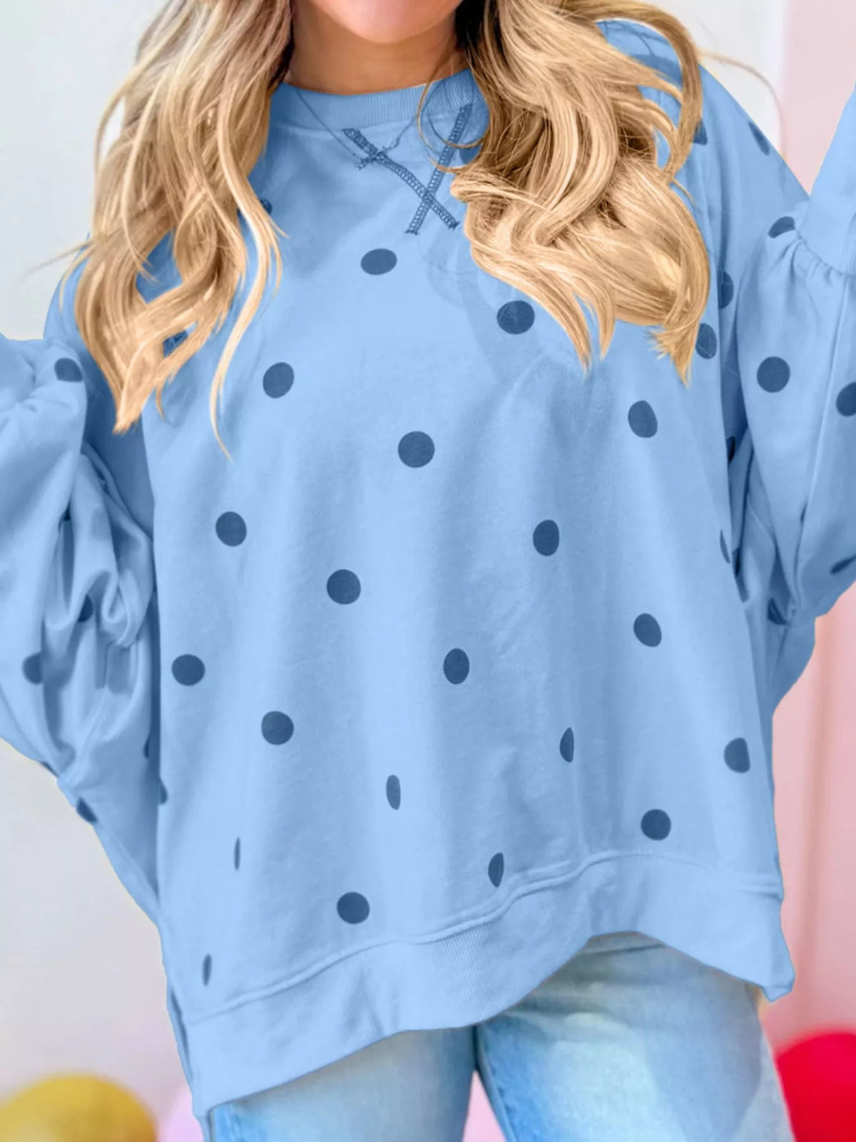 Oversized polka dot sweatshirt with side slit by Trendsi, featuring a relaxed fit and stylish design in the image.