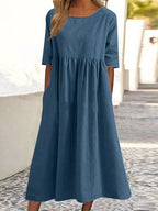Plus size midi dress with round neck and pockets by FitiqueFit, casualwear style, shown on a model with a relaxed fit.