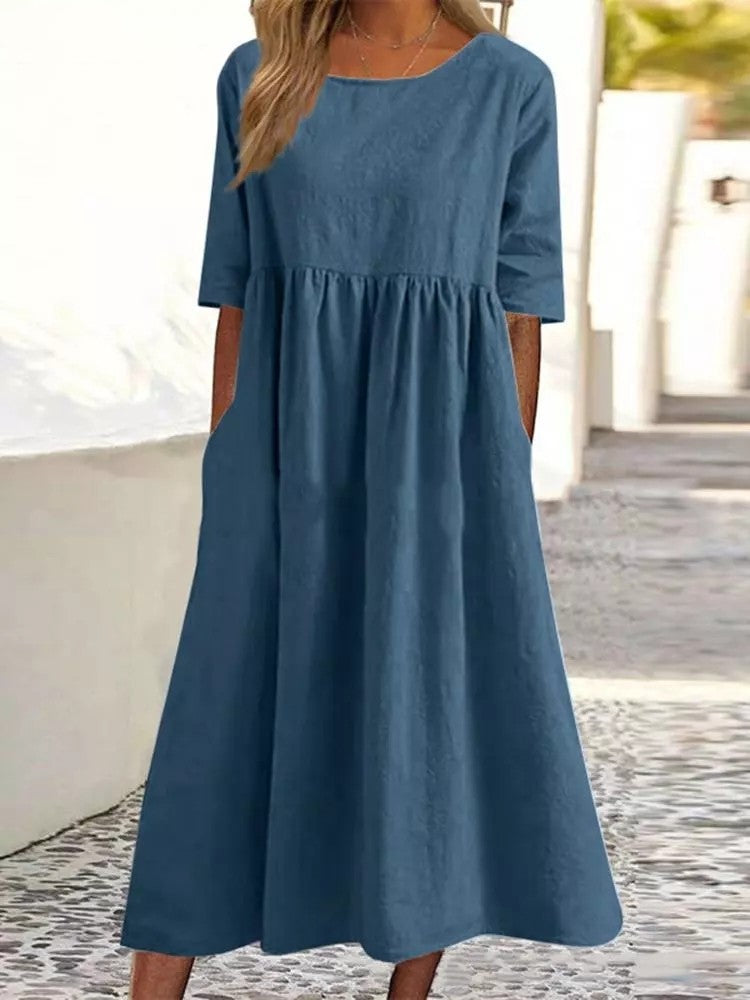 Plus size midi dress with round neck and pockets by FitiqueFit, casualwear style, shown on a model with a relaxed fit.
