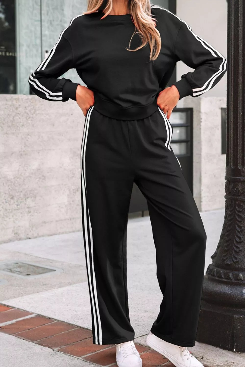Striped detail crewneck pullover and elastic sweatpants set by Trendsi, featuring a comfortable matching loungewear outfit.