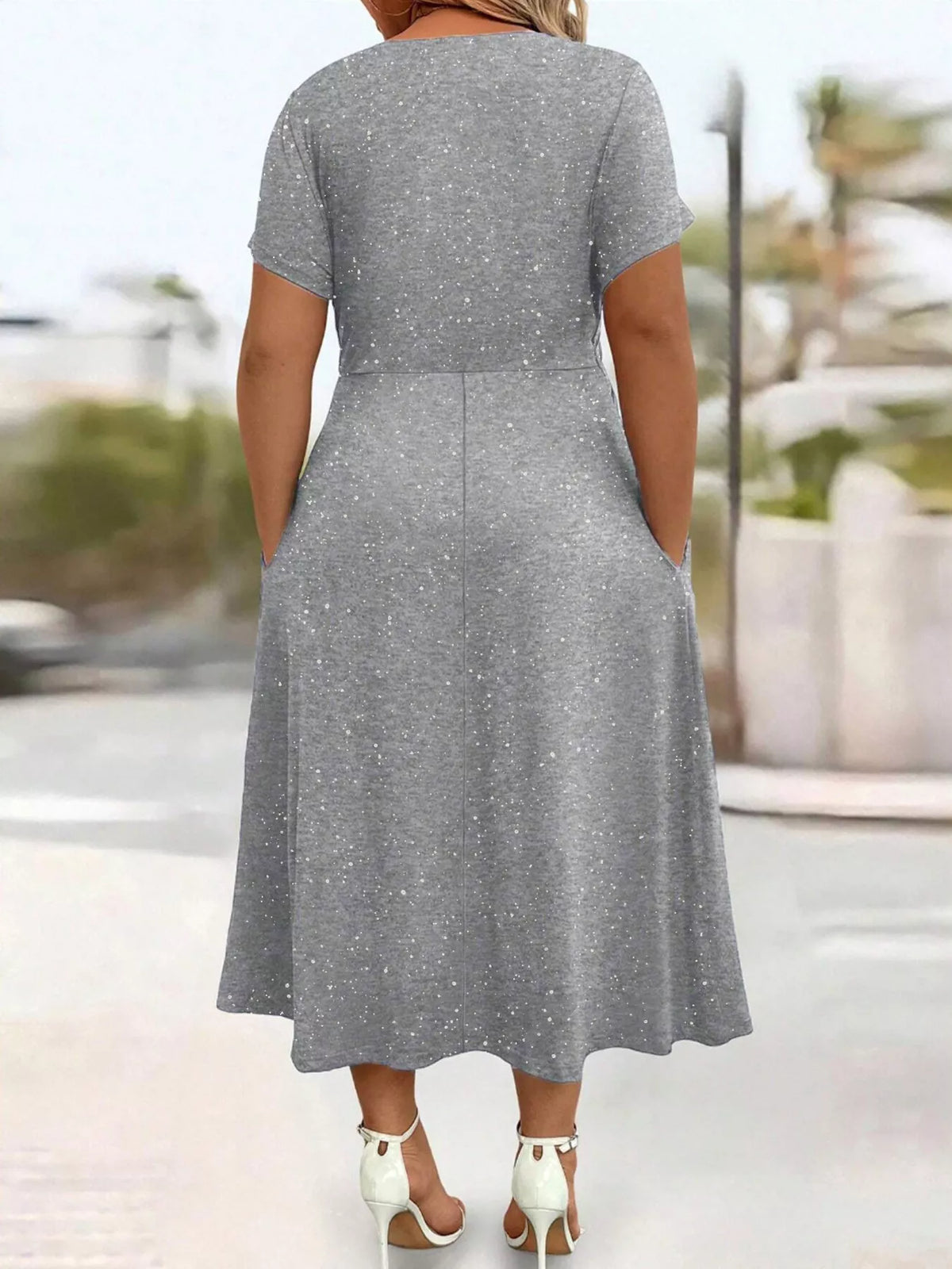 Plus size glitter flutter sleeve midi dress by Trendsi, featuring a stylish full-length dress with shimmering fabric and flutter sleeves.