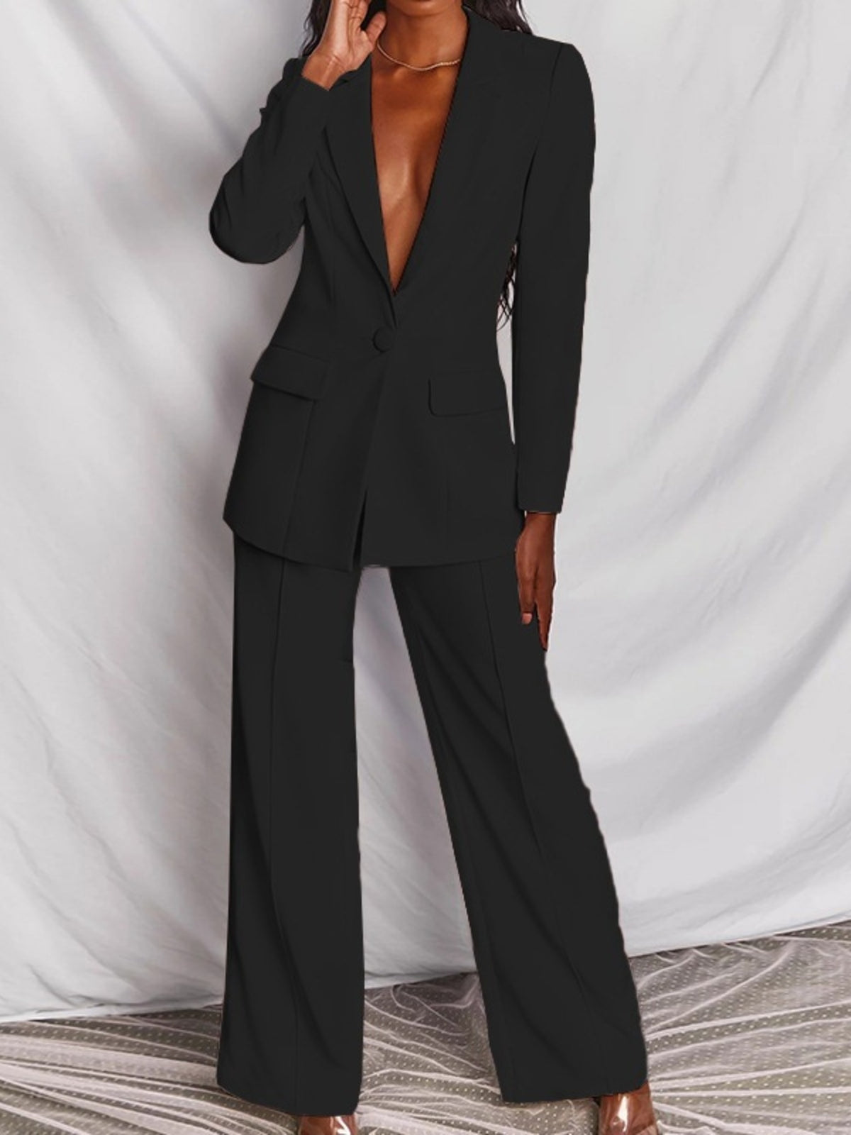 Plus size blazer and wide-leg pants matching set by Trendsi, featuring a one-button blazer and stylish wide-leg trousers.