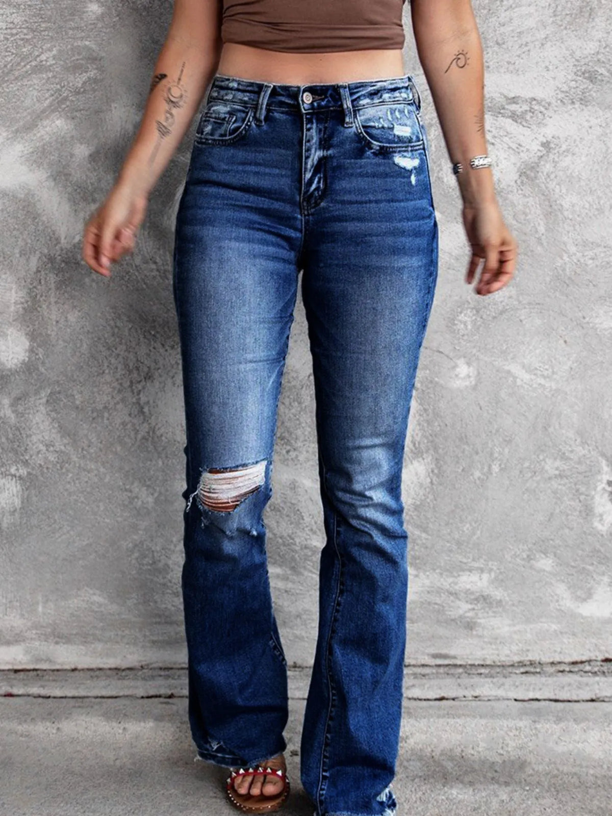 Distressed flare denim jeans from Plush Fashion Hub featuring a high-waisted fit and ripped detailing for a trendy look.