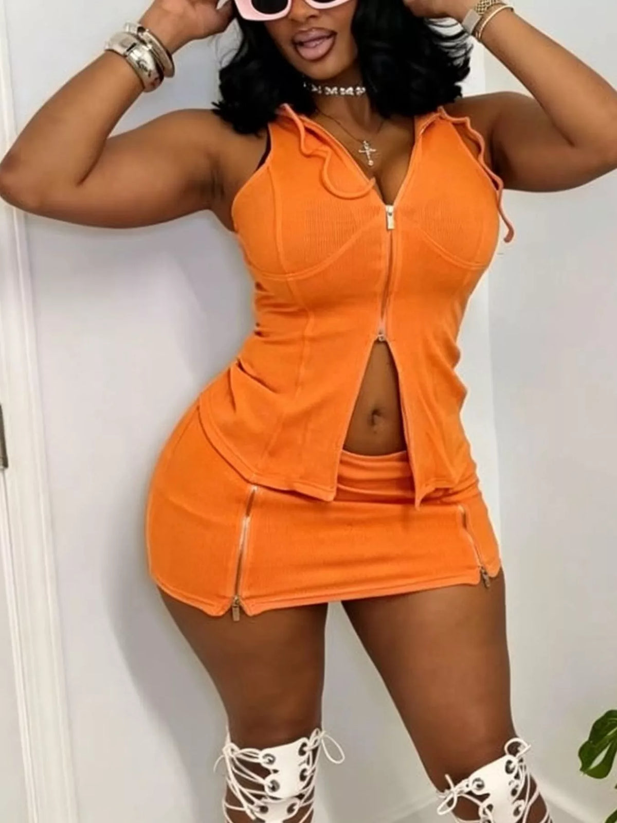 Plush Fashion Hub hooded zippered sleeveless top and skirt set, stylish two-piece outfit with a modern design and comfortable fit.