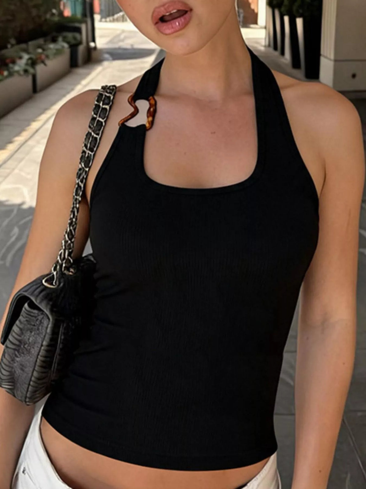 Ribbed halter neck tank top by Plush Fashion Hub, showcasing its fitted ribbed fabric and stylish halter neckline.