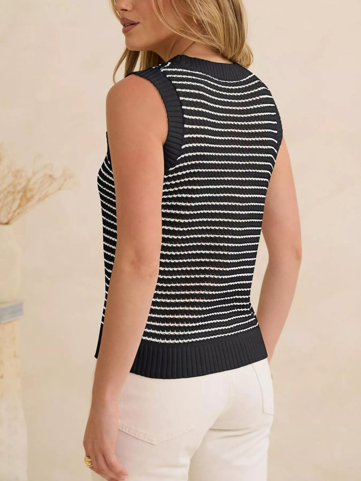 Striped knit sweater vest from Plush Fashion Hub featuring a cozy design and colorful horizontal stripes.