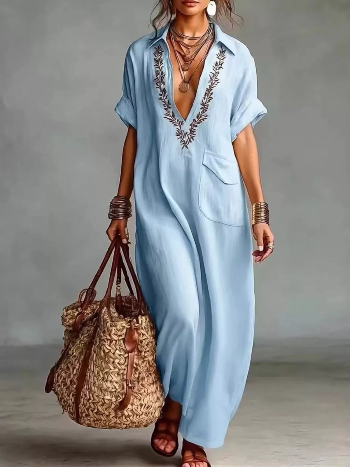 Plus size bohemian embroidered maxi dress by Trendsi featuring vibrant embroidery and flowing fabric.