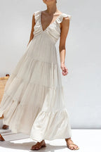 Women's 100% cotton ruffled V-neck tiered midi dress by Trendsi, featuring a flowy silhouette and feminine ruffle details.