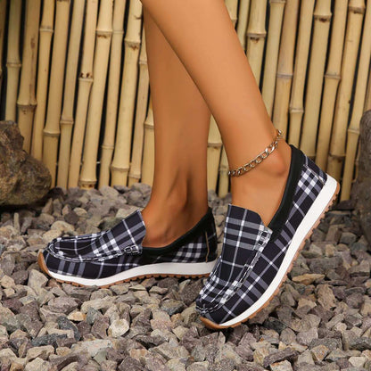 Plaid Round Toe Slip-Ons on rocky ground showcasing style and comfort.