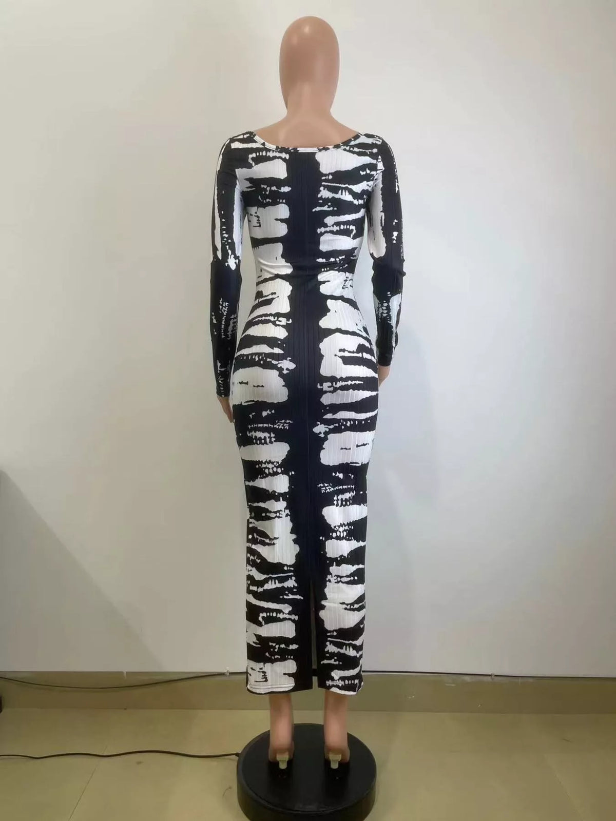 Colorful tie-dye long sleeve maxi dress by Plush Fashion Hub, featuring a flowing silhouette and vibrant swirling patterns.