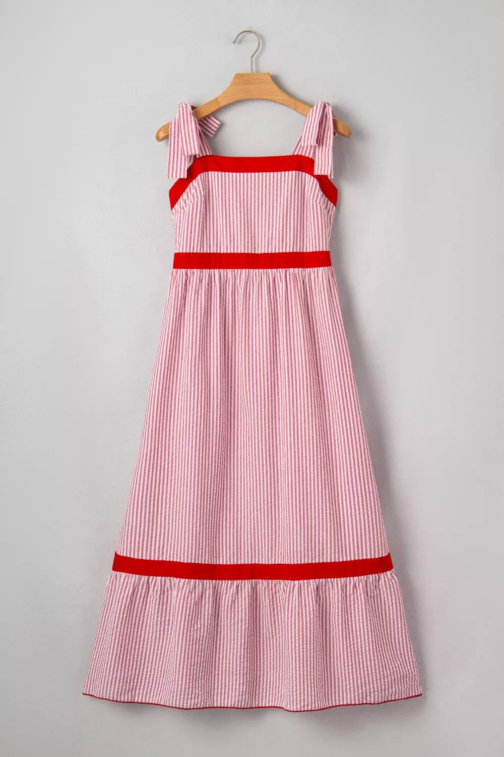 Plush Fashion Hub stripe bow knot straps contrast trim high waist ruffle hem maxi dress, showcasing its elegant design and flowing fabric.